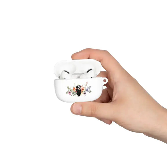 Custom AirPods case with pet face design held in hand, featuring a cartoon pet portrait with floral accents by Meraki Pet.