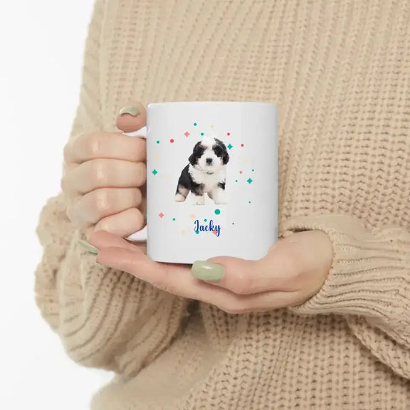 Person holding a custom pet photo mug featuring a puppy, perfect for celebrating special pet anniversaries with coffee.