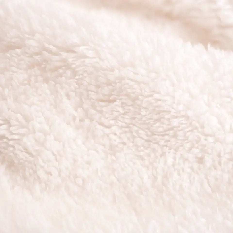 Close-up of soft Sherpa fleece texture on a white personalized Halloween throw blanket.