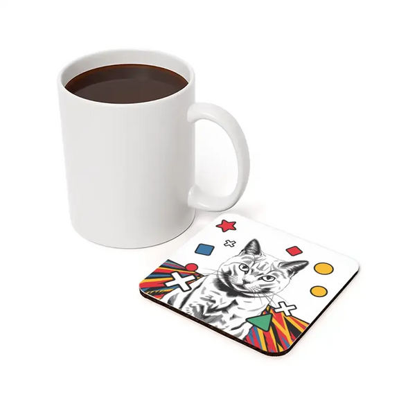 Black and white cat illustration coaster with pop art design next to a white mug, featuring geometric shapes in vibrant colors.