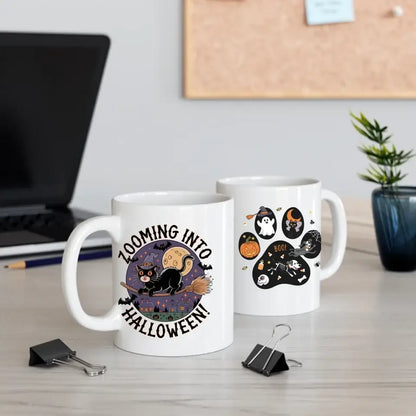 Personalized Halloween ceramic mugs with black cat design and playful Halloween themes on a desk.