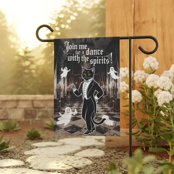 Dance with the Spirits garden flag featuring a tuxedo cat and friendly ghosts, perfect for Halloween decor in a garden setting.