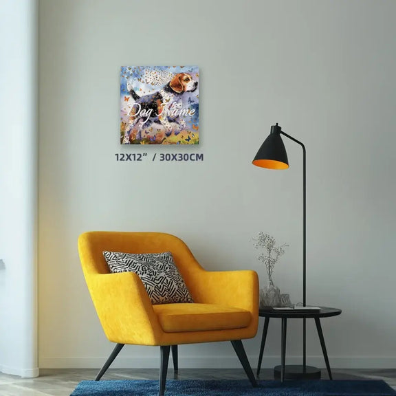 Beagle watercolor canvas painting with butterflies, 12x12 inches, displayed on a wall above a yellow chair with a pillow.