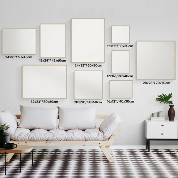 Various sizes of blank frames arranged on a modern living room wall above a white couch, showcasing home decor possibilities.