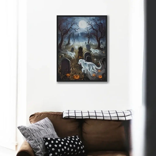 Halloween framed poster with ghostly dogs in a graveyard, under a full moon, on a living room wall above a brown sofa.