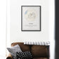 Personalized dog journey map artwork framed above a cozy brown sofa with decorative cushions.