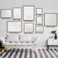 Wall display of personalized cat memorial star charts in various sizes, featuring elegant frames above a modern white couch.