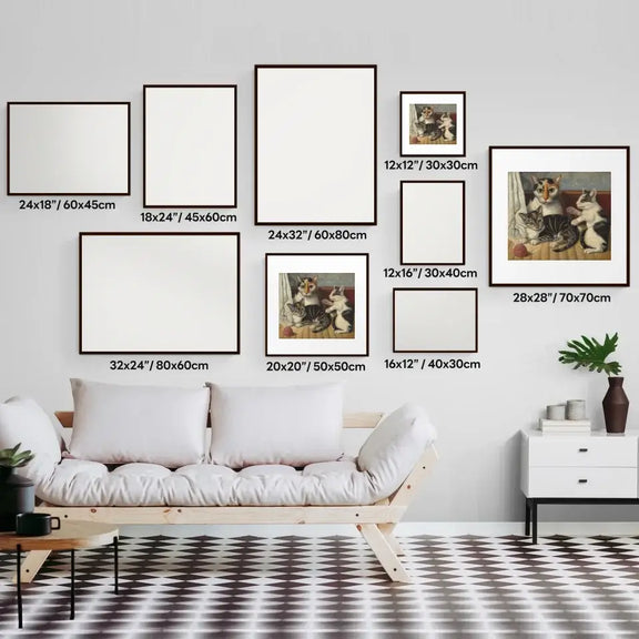 Gallery wall of various framed art prints including "Cat and Kittens" on a modern living room wall above a white sofa.