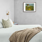 Cozy bedroom with a classic hunting dog art print above the bed, featuring a dog watching pheasants in a natural setting.