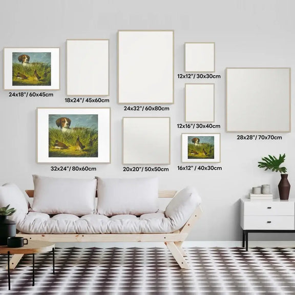 Art gallery wall display featuring classic hunting dog art prints in various sizes and white frames, with sofa and plant decor.