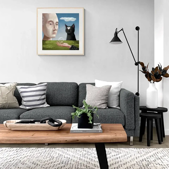 Living room with "A Cat’s Philosophical View" art print, exploring the connection between cats, humans, and nature.