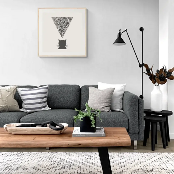 Modern living room with Nature’s Observer art print featuring cat silhouette and animals, emphasizing natural observation.