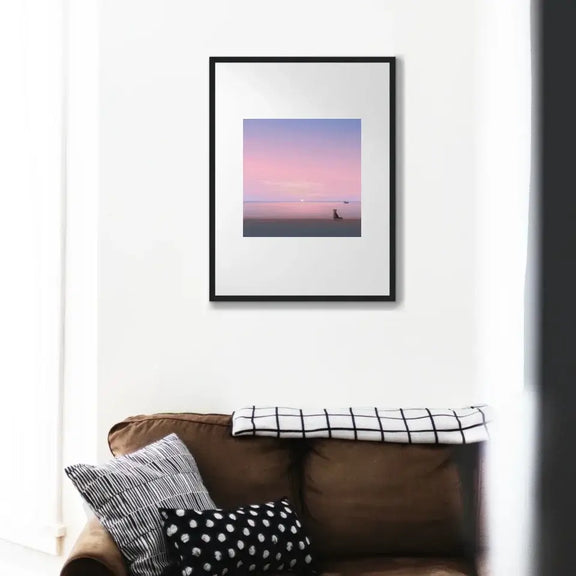 "Silent Paws Before Sunset art print featuring a cat and sunset, displayed in a modern living room setting."