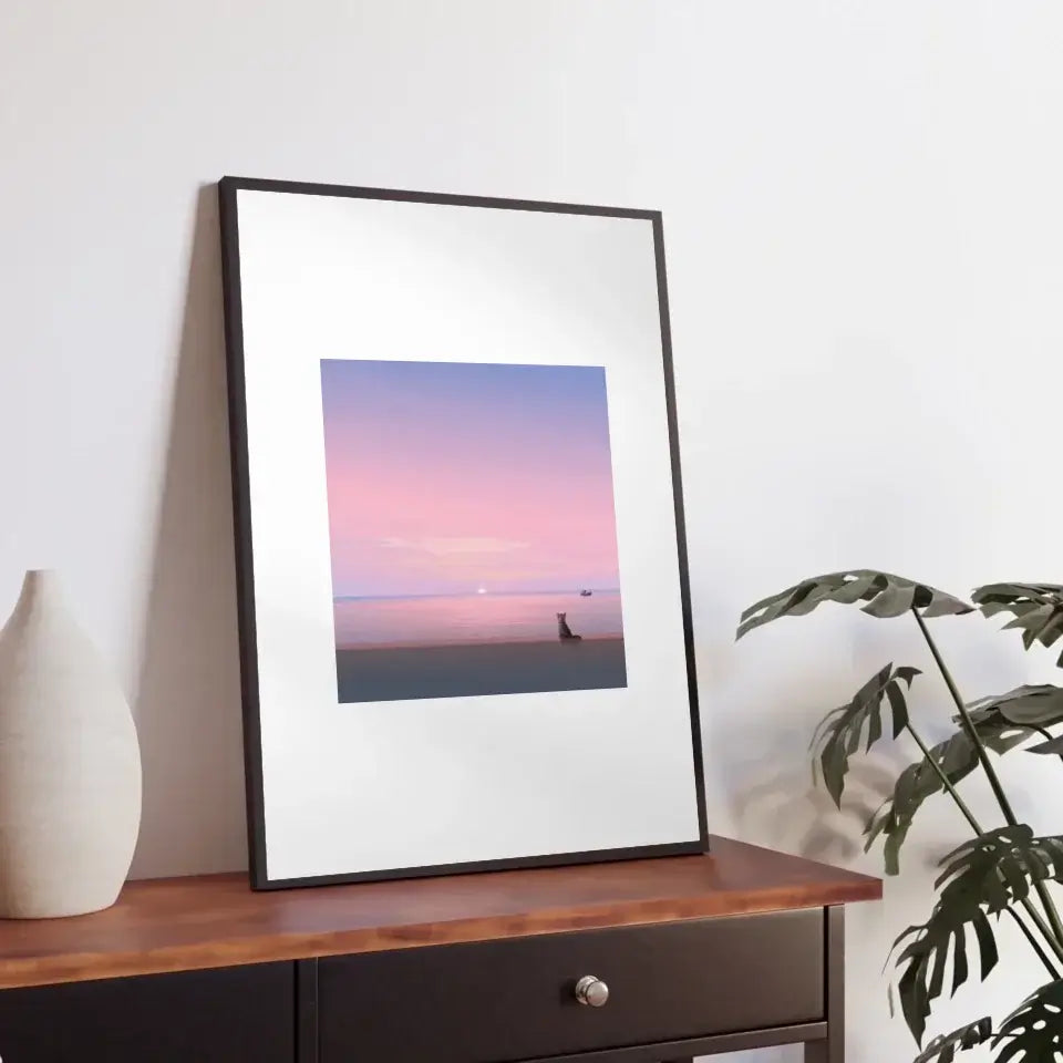 "Silent Paws Before Sunset art print framed on a wooden table, featuring a serene sunset with a cat silhouette and calming pastel tones."