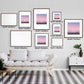 Gallery wall display of framed Silent Paws Before Sunset art prints in various sizes above a modern sofa with cushions.