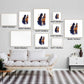 Multiple framed sizes of Cityscape Cats: New Orleans Edition watercolor art displayed above a modern sofa.