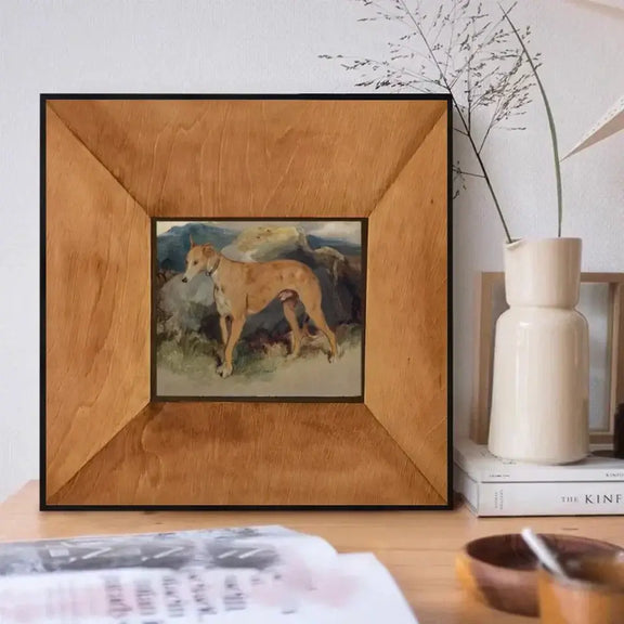 Deerhound oil painting art print in wooden frame on a desk, showcasing vibrant colors and intricate details, perfect for nature lovers.