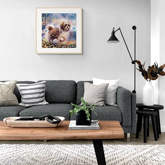 Stylish living room with framed personalized watercolor painting of a dog and butterflies on the wall.