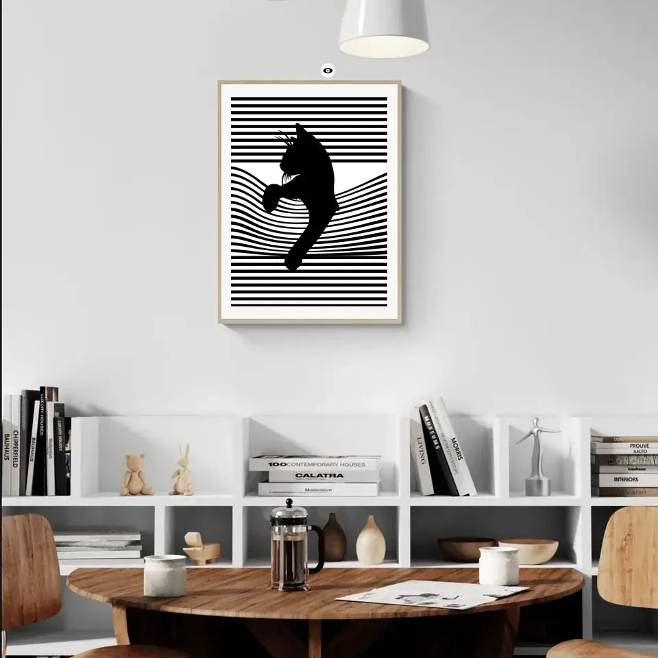 Black cat striped wall art hanging in a modern living room interior setting with wooden furniture and bookshelves.