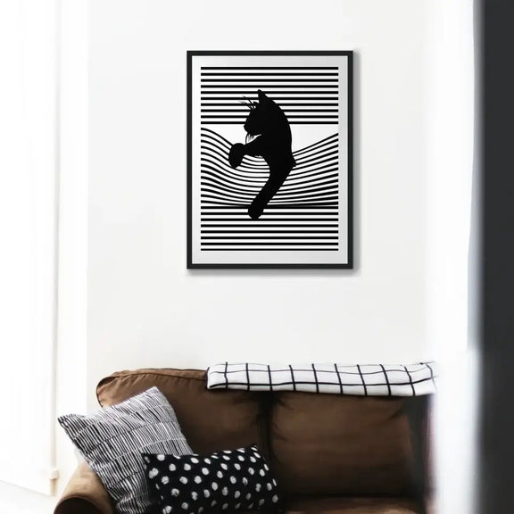 Black cat wall art with striped background, elegantly displayed above a cozy couch, ideal for cat lovers and home decor enthusiasts.