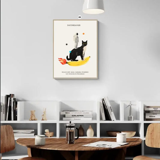 Astronaut and cat on banana rocket art print in modern living room setting.