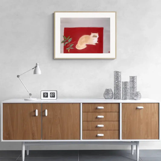 Modern living room with Japanese cat painting by Togyu Okumura, featuring a serene white cat on a red background.