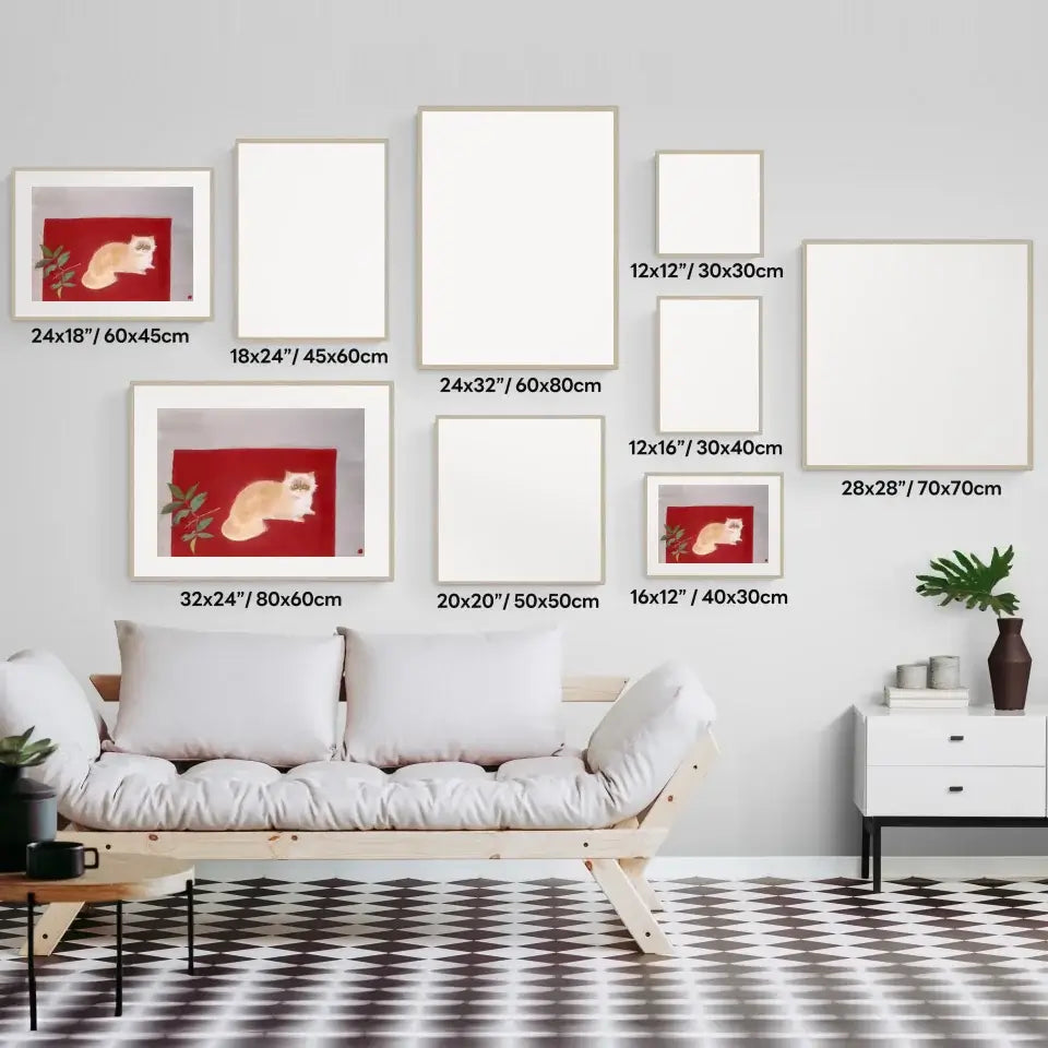 Gallery wall layout with various blank frames featuring a Japanese cat painting, displayed above a modern sofa.