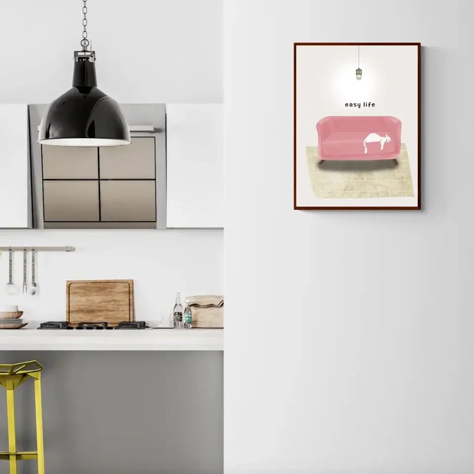 Modern kitchen with framed art of a cat napping on a pink sofa, adding a touch of tranquility and style to the wall decor.