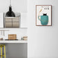 Cat in a Cup Art Print on kitchen wall, featuring a whimsical cat inside a cup, adding charm and quirkiness to home decor.