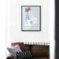 Playful cat with yarn art print hanging in a cozy living room setting.