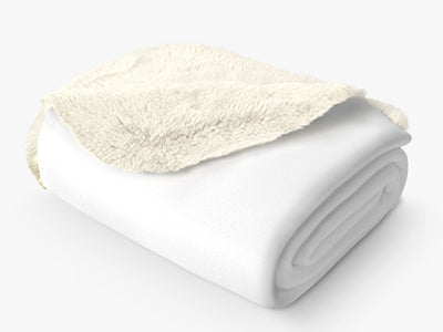 Soft white fleece and sherpa blanket folded neatly on a light background.